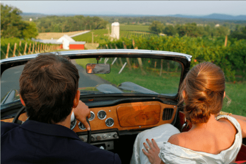 a husband and wife driving