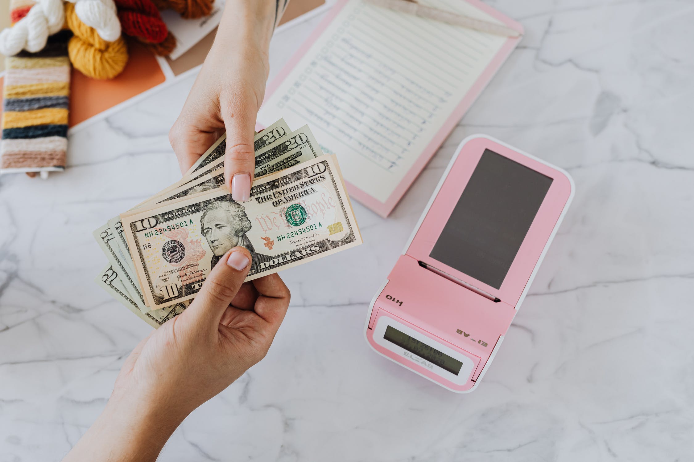 close up of a person handing someone else money