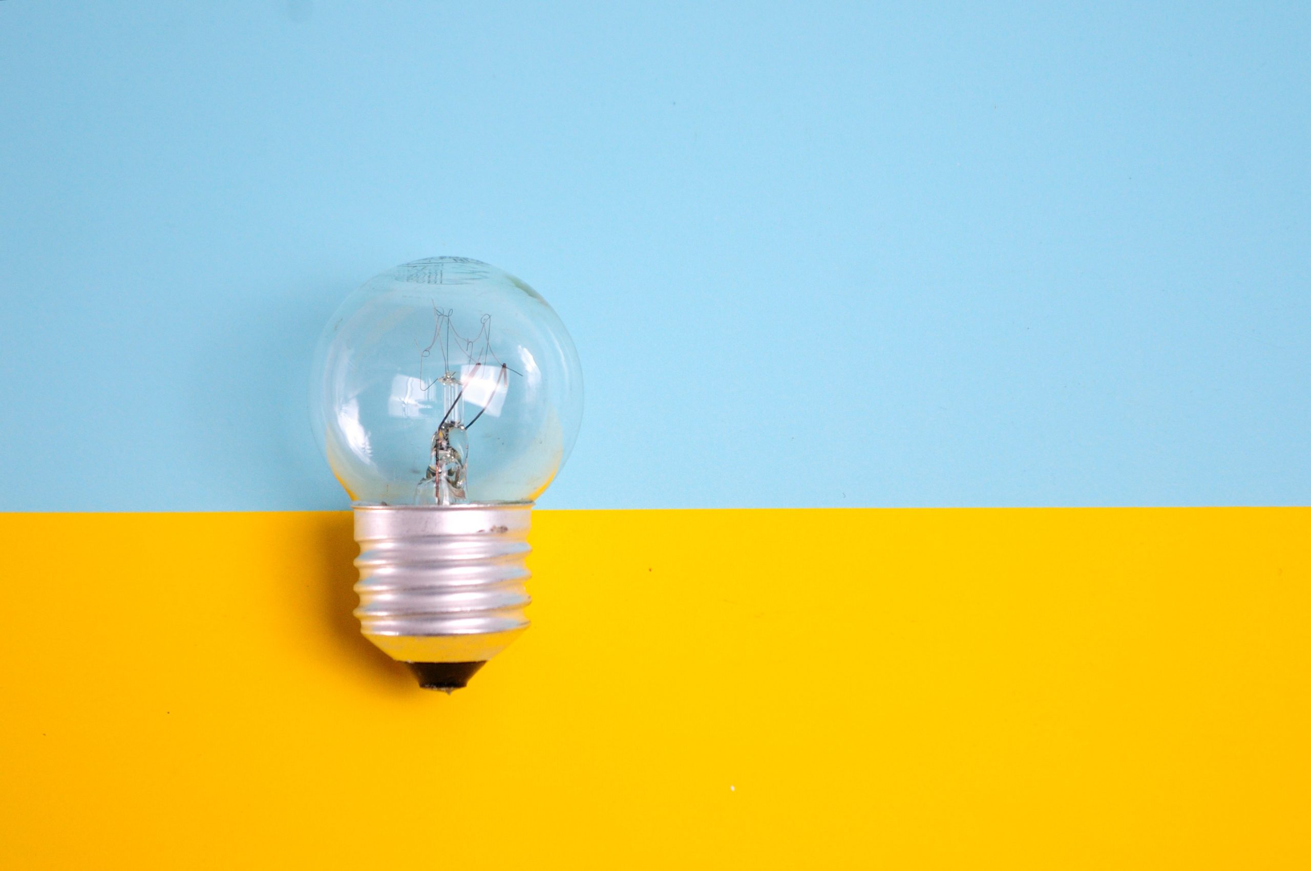 lightbulb in front of a blue and yellow background