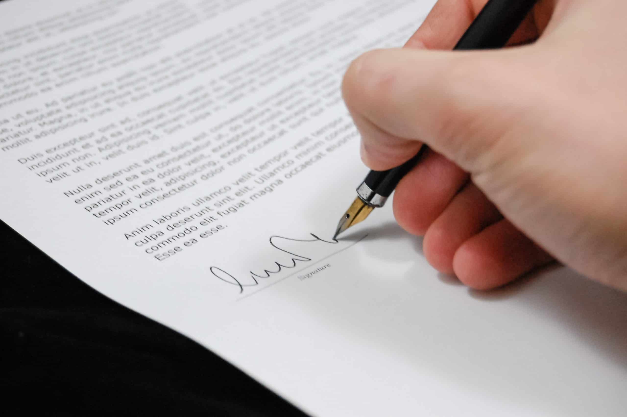 person signing a document