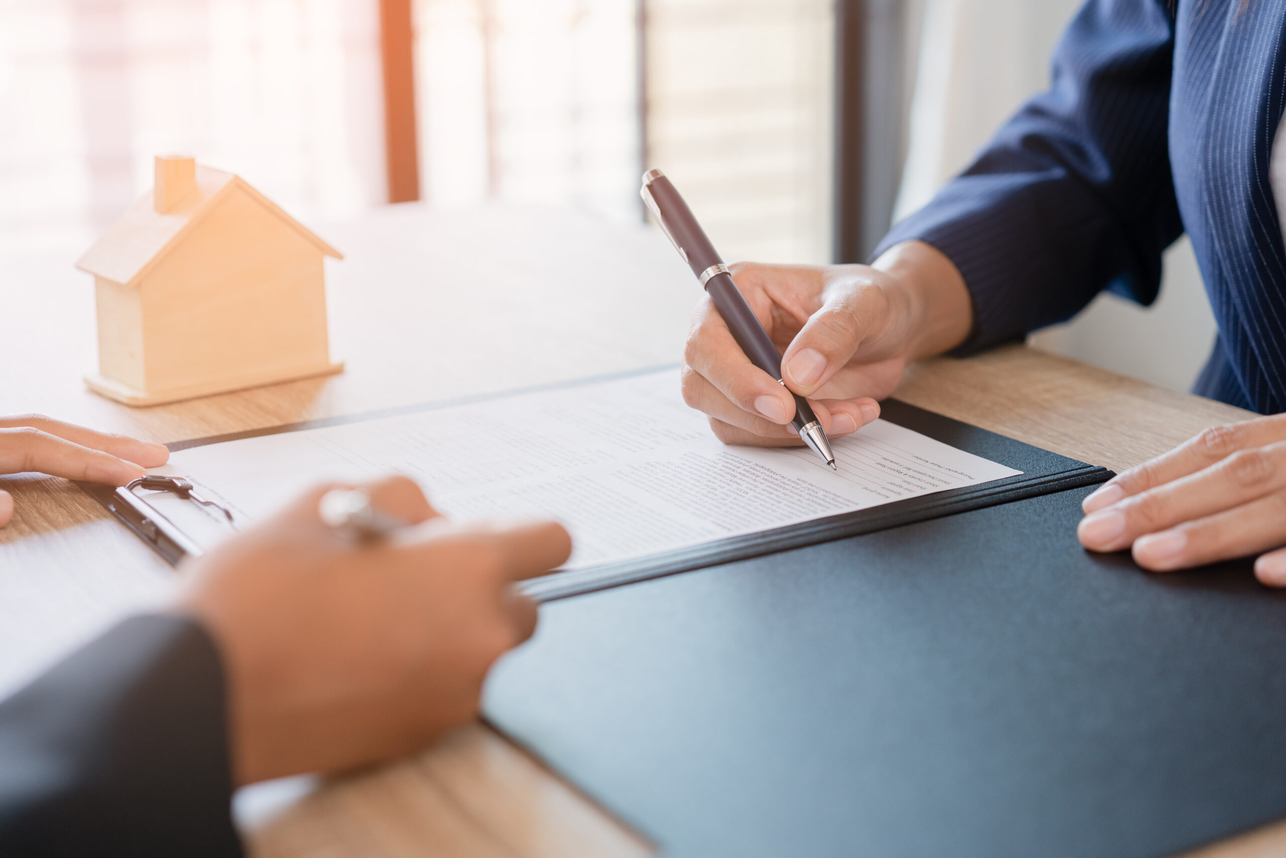 Business owner signing a business purchase agreement